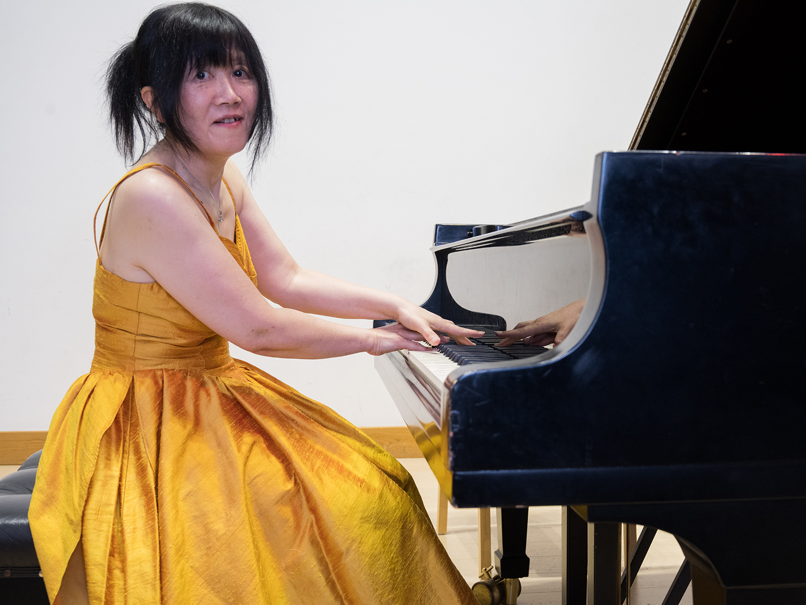 Haruko seated at piano